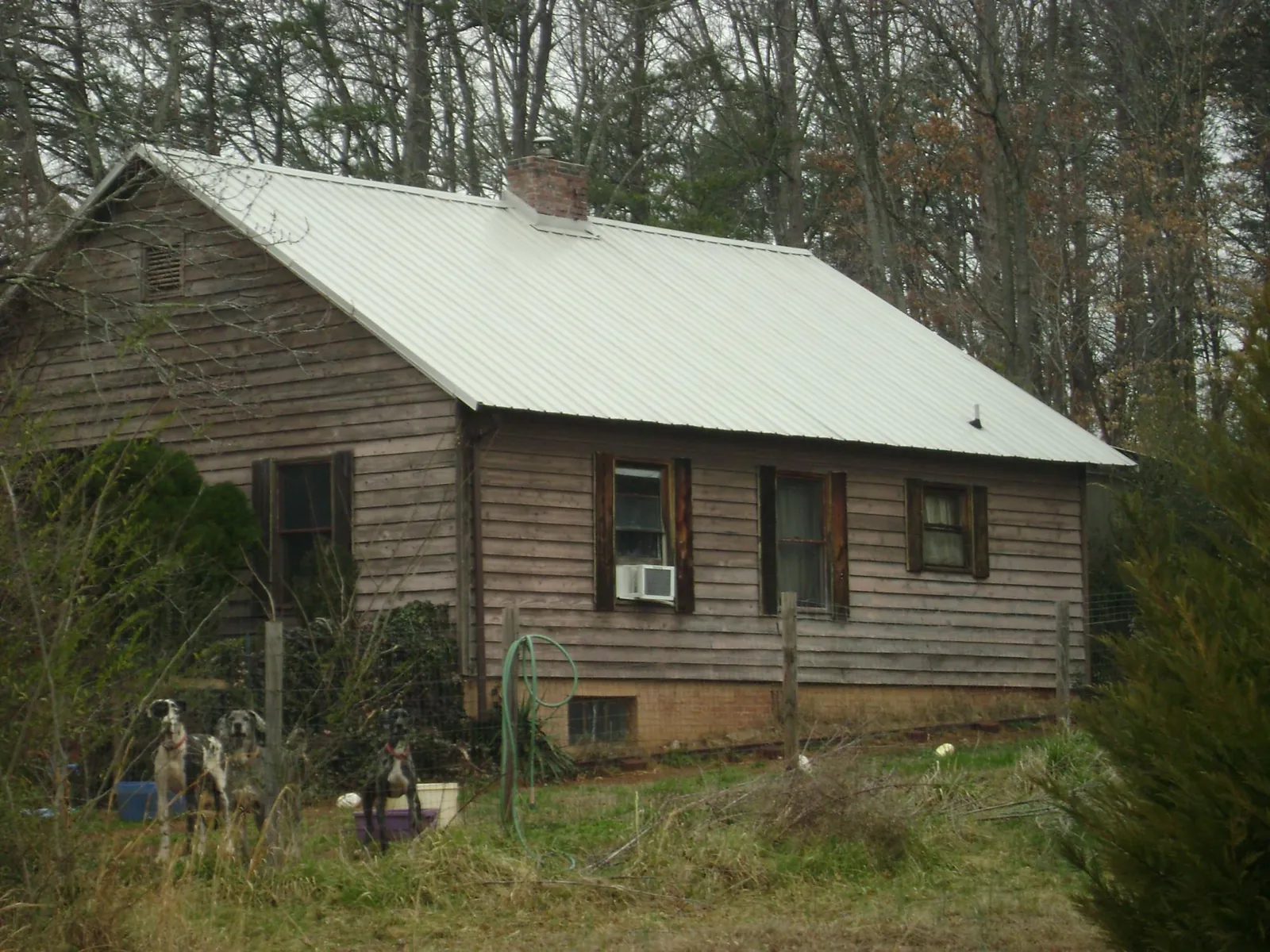 White metal roof on an old wood sided farmhouse, from a Metal Roof Installation job in West Union